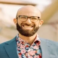 Mike Kohn, Chief People Officer, Kevel seen with a bright smile on his face